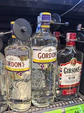 Display of gin bottles in a retail setting showcasing various brands Stock Photos