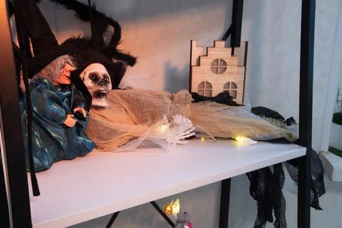 Display of Halloween decorations with witch, skeleton, and haunted house in.. Stock Photos