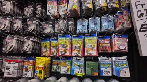 Display of hooks and plastic lures for fishing inside Canadian sport store... Stock Footage 311270956