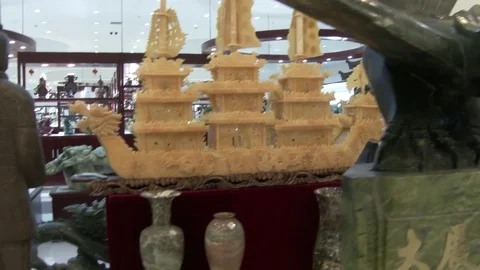 Display of huge jade pieces including a ship and mythical bird, 4K. Stock Footage 79706891