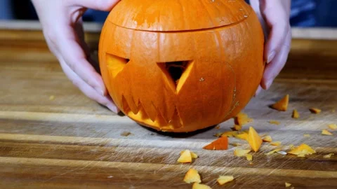 Display of large jack-o'-lantern made from traditional carved pumpkin with li Stock Footage 272459646