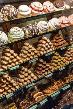 A display of many different types of pastries, including cupcakes and donuts Stock Photos