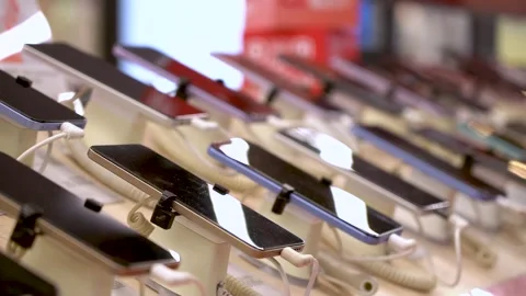 A Display of Modern Smartphones in a Retail Setting Showcasing Various Models Video stock 332653196