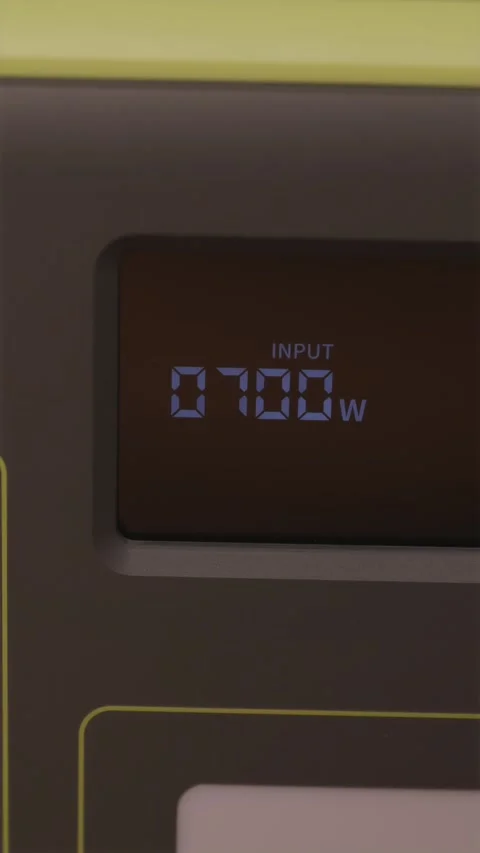 Display panel of portable power station showing input charging watts Video stock 347068992
