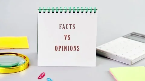 A display shows the words facts vs opinions on a small calendar. Nearby, there Stock Footage 341662076