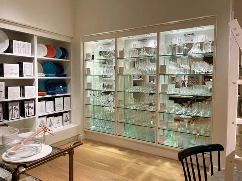 A display with stemware and barware glasses at a Williams Sonoma store at an  Stock Photos