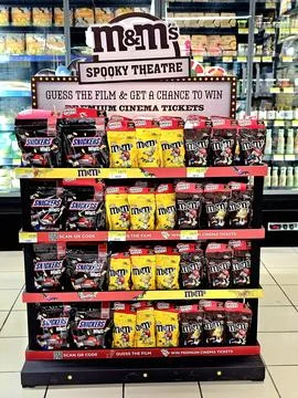Display in a store, featuring M&amp;M's and Snickers candies. Fotos Stock