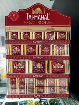 Display unit showcases numerous small, rectangular boxes of "Taj Mahal Saffron. Fotos Stock
