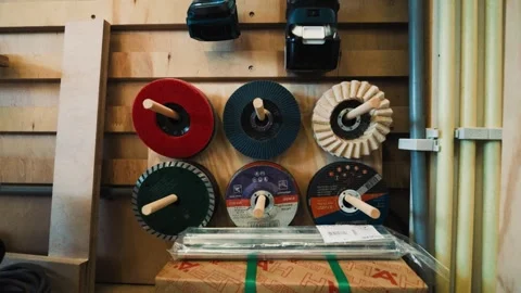 Display wall of abrasive discs and polishing wheels inside a woodworking Stock Footage 334996441