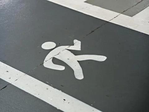 Displayed sidewalk in gray with white bars on the side and painted running ma Stock Photos