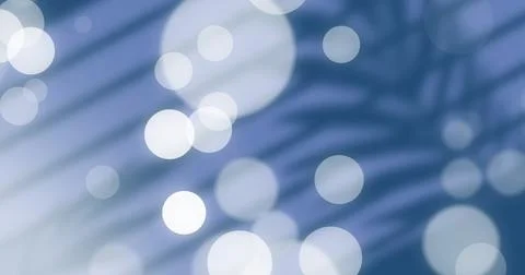 Displaying abstract pattern melding soft light orbs and palm shadows in graphic Stock Photos