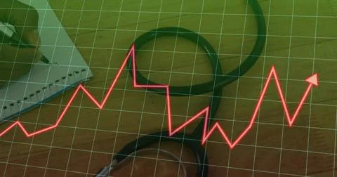 Displaying black stethoscope looping across wooden clinic desk, with green grid Stock Photos