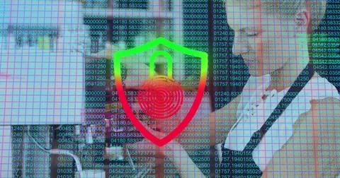 Displaying business professionals analyzing code overlay in office, with laptop Stock Photos