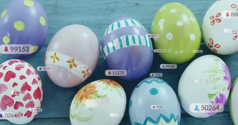 Displaying cluster of decorated eggs sitting on blue painted plank surface, with Stock Photos