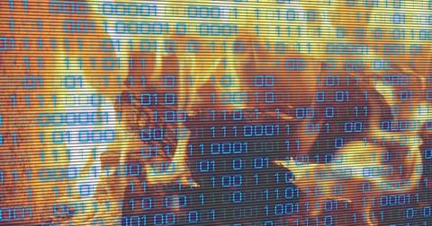 Displaying cyan binary digits over orange flames on screen, showing scanlines 스톡 사진