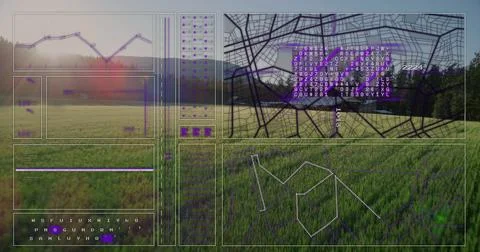 Displaying digital data overlaying grassland, with line chart, map grid and data Foto stock