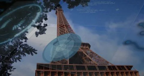 Displaying Eiffel Tower rising at Tower base against sky, showing tree branches 写真素材