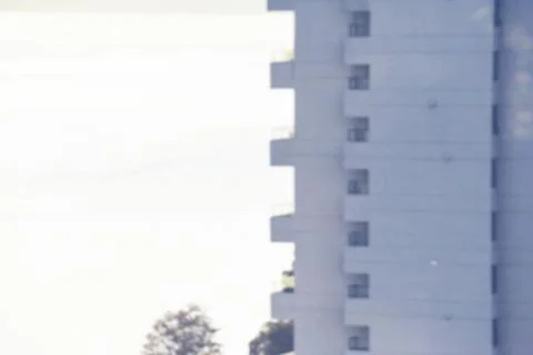 Displaying flat design facade on right with balconies, windows, power lines and Stock Photos