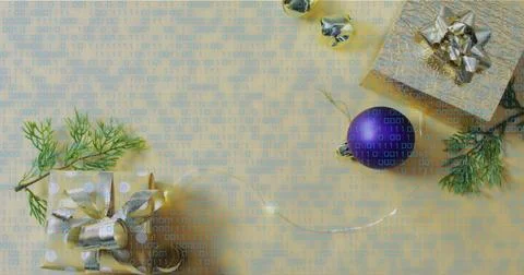Displaying flat-lay scene showing wrapped gifts with purple bauble, silver Stock Photos