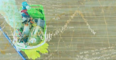 Displaying frog-shaped plush backpack resting on wooden floor with stock charts Stock Photos