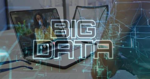 Displaying front laptop projecting BIG DATA at desk with pen, woman in yellow Stock Photos
