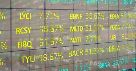 Displaying glass panel overlaying grid on trading floor, showing ticker codes Foto stock