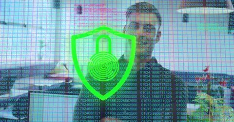 Displaying green shield emblem with code streams over office desk, with compu Stock Photos