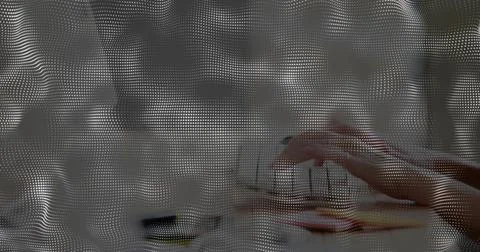 Displaying halftone dot wave overlay across office workspace, obscuring keybo Stock Photos