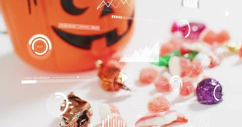Displaying Halloween candy on white tabletop, with jack-o-lantern bucket, Stock Photos