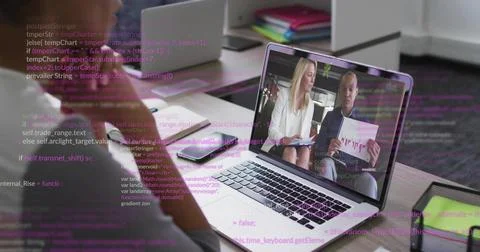 Displaying laptop screen showing remote meeting at office desk, with printed Stock Photos
