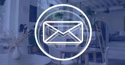 Displaying large envelope icon inside rings overlaying cafe, featuring wooden Foto stock