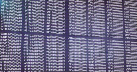 Displaying numeric grid filling dark office desk monitor display, with seven Stock Photos