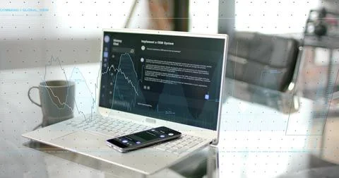 Displaying open silver laptop in modern home office, showing CRM dashboard with Stock Photos