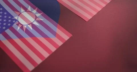 Displaying overlapping paper flags on deep red mat surface, with United States Stock Illustration