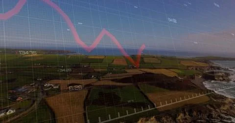 Displaying red downward trending graph arrow above coastal farmland, with data Stock Photos