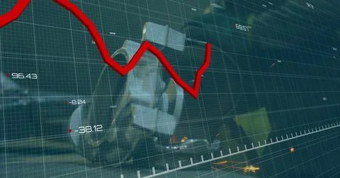 Displaying red jagged line graph cutting across factory numeric grid overlay, Stock Photos