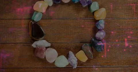 Displaying ring of polished semi-precious stones on wooden planks, with vivid Stock Photos
