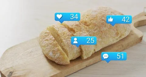 Displaying rustic bread loaf resting on wood board on table with flour dusting, Stock Photos
