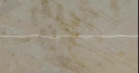 Displaying stone slab in close-up with white dotted waveform line across center, Stock Photos