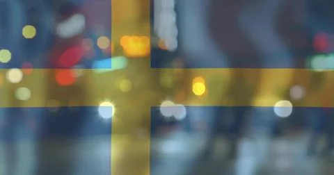 Displaying Swedish flag over blurred night street, showing bokeh, headlights, Ilustração Stock