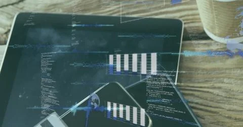 Displaying tablet showing code and waveform overlays on wooden tabletop with 写真素材