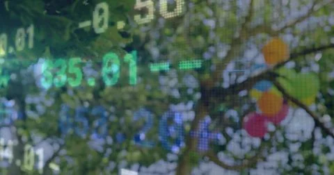 Displaying translucent pixel grid with green blue numerals over park foliage, Foto stock