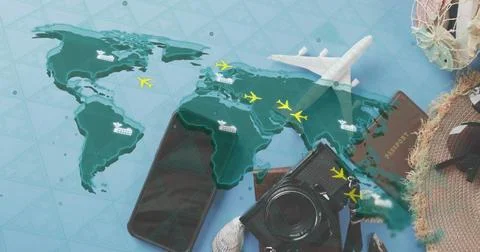 Displaying travel flatlay on blue table showing world map with model airplane, Stock Photos