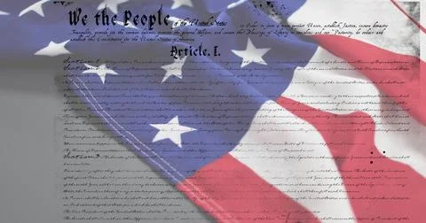 Displaying US flag overlaying Constitution page in close-up showing We header Stock Photos
