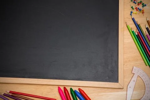 Displaying vector top down wooden chalkboard on desk showing colored pencils, Stock Photos