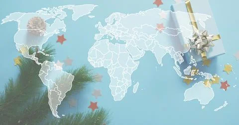 Displaying white world map outline across blue sheet showing pine branch, gift Stock Photos