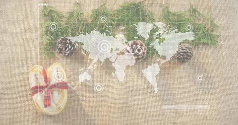 Displaying white world map overlay on burlap, with conifer sprigs, pinecones, Stock Photos