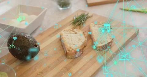 Displaying wooden board with rustic bread, avocado, rosemary, crumbs on stone Stock Photos