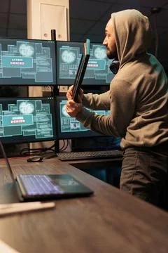 Displeased angry hacker throwing keyboard in office Foto stock