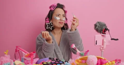Displeased Asian lady cannot make manicure paints nails doesnt like nail polish Stock Footage 156970469